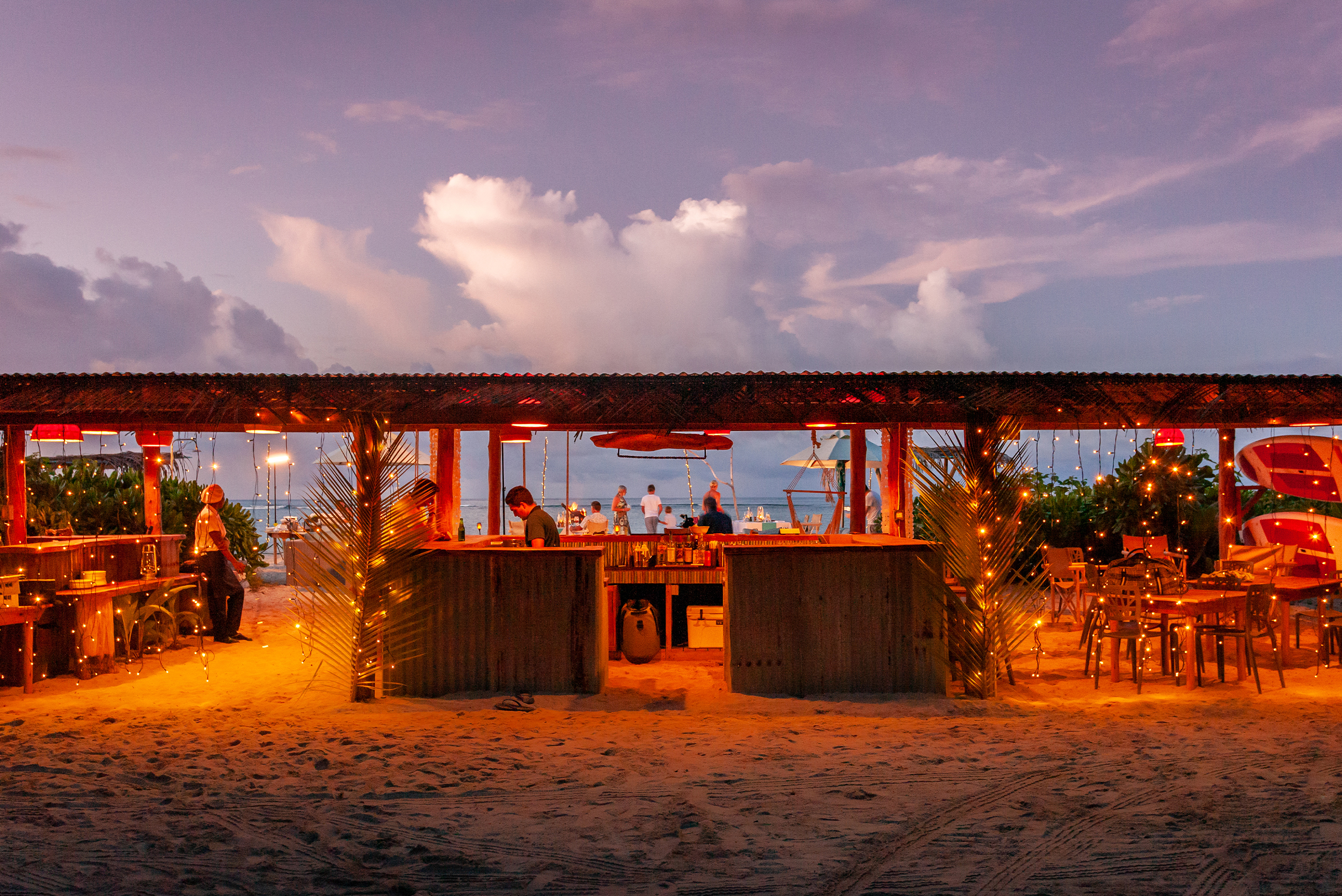 alphonse island about alphonse island 4col 4th 50percent 1 photo alphonse island guests having sundowners at beach bar